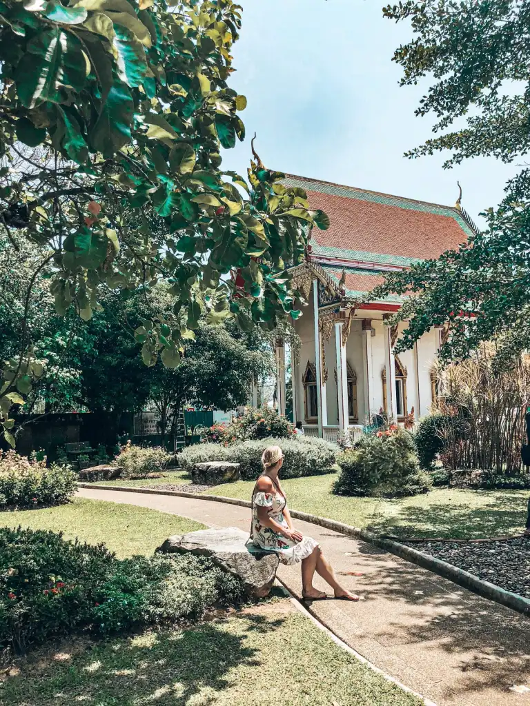 Woman sitting in the grounds of Wat Chalong