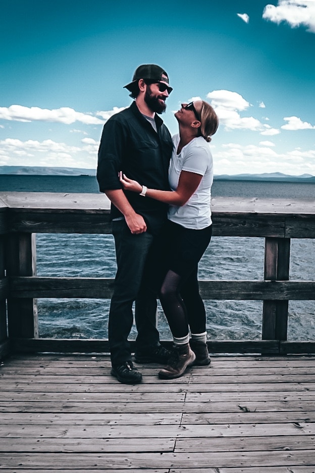 Couple hugging in front of Yellowstone Lake