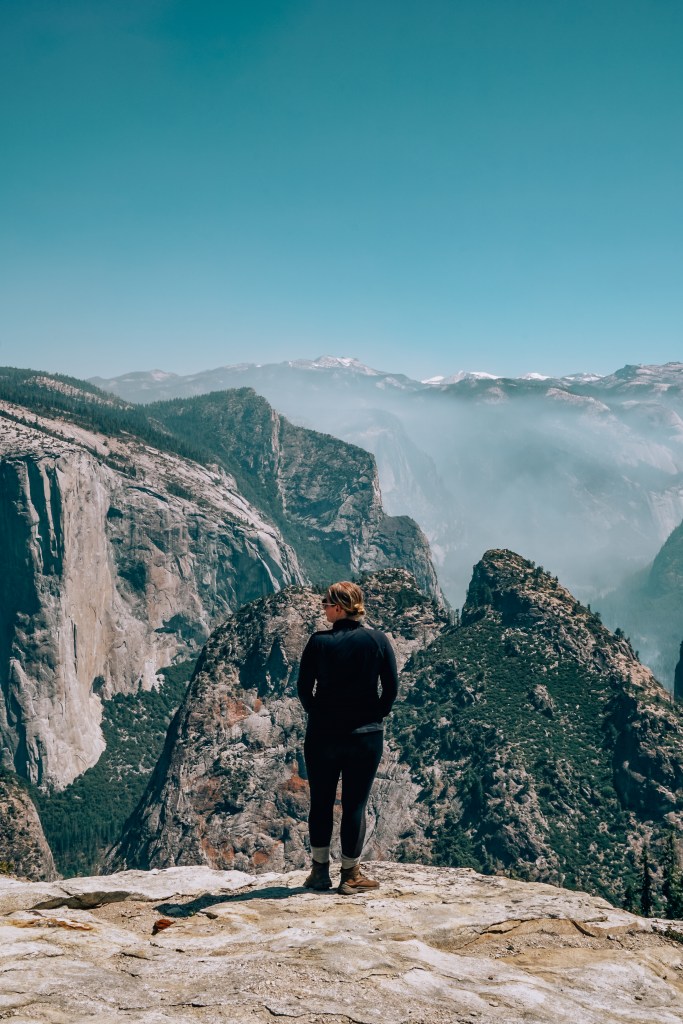 Woman standing in front of ledge leading to Dewey Point in Yosemite