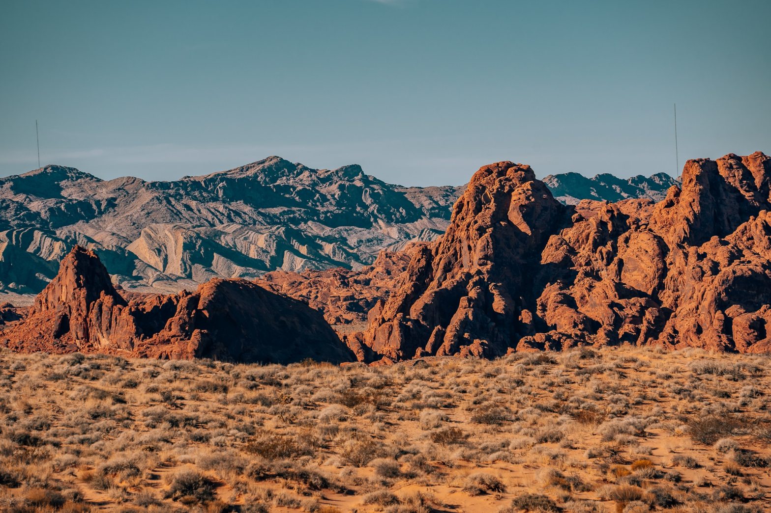 Mountain and rocky layers at Valley of Fire State Park with the red rocks in front and the mountains in the background