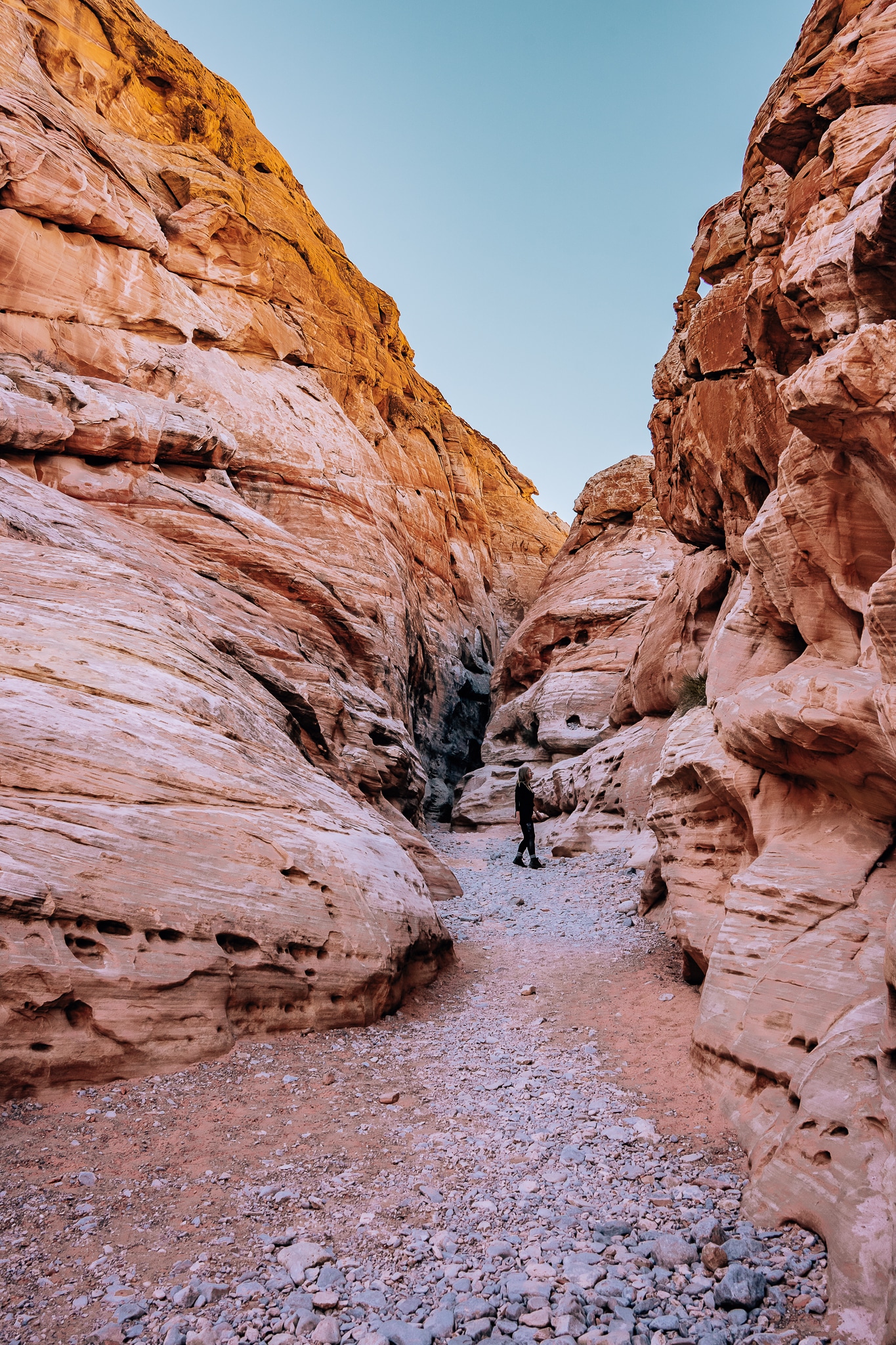 Woman standing in a slot canyon in the White Domes hiking trail at Valley of Fire State Park