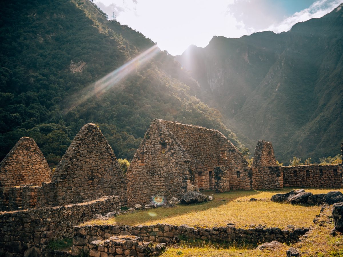 Light peeking behind the Andes Mountains at a stop with Incan Ruins along the Inca Trail
