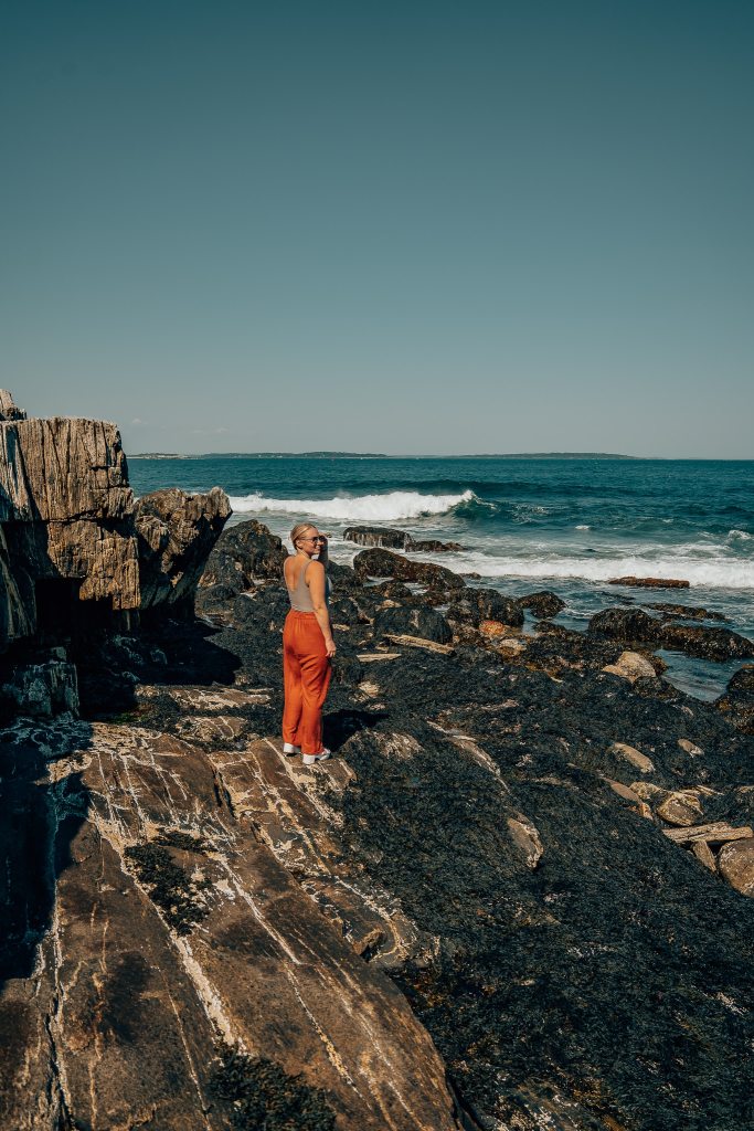 Woman standing on a rocky beach