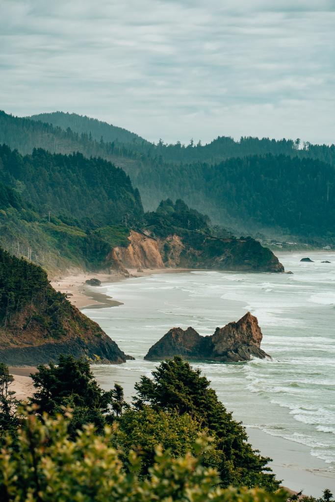 View of the Oregon coast from above with the beach and rocks out in the water