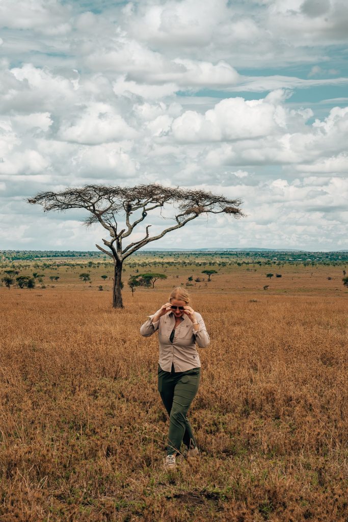 Woman walking in Serengeti National Park on safari