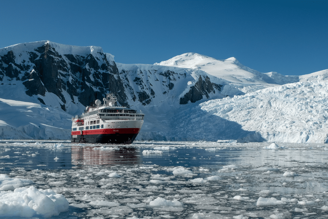 Antarctica cruise ship next to the ice mountains