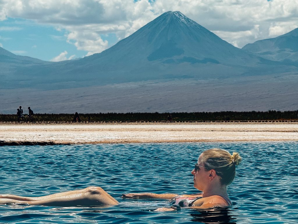 Woman floating in a salt lagoon named Laguna Piedra in the Atacama Desert of Chile