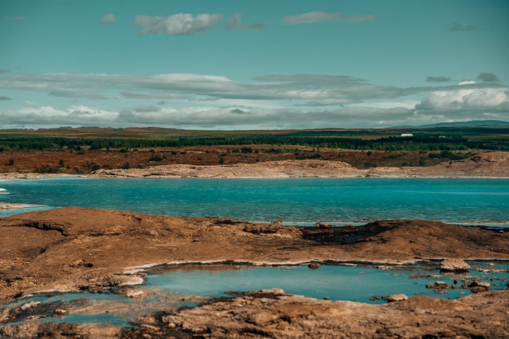 View of hot spring's bright blue water in Geysir, Iceland